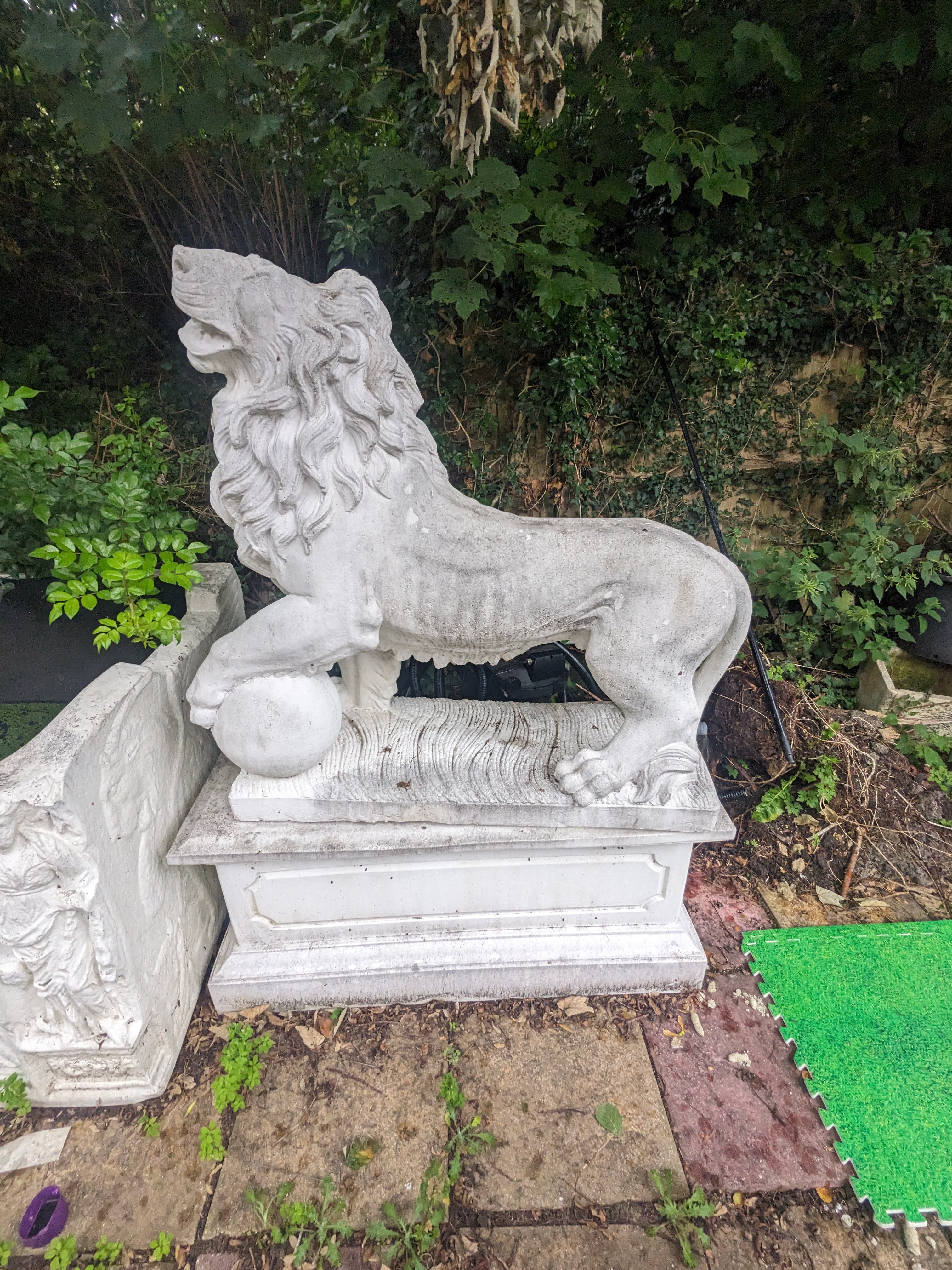 A pair of re-constituted stone models of lions standing upon rectangular plinths, fitted as fountains, Height 160cm., Viewing in Forest Row by arrangement. Purchaser to arrange for removal within one week of the sale dat